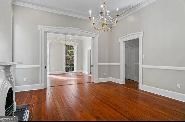 a kitchen with stainless steel appliances a sink dishwasher stove and white cabinets with wooden floor