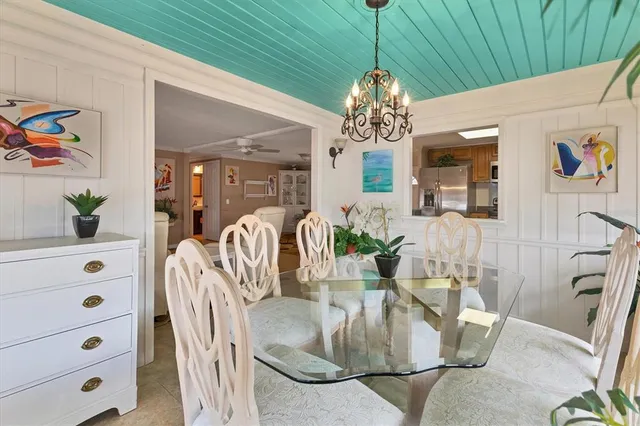 a dining room with furniture a chandelier and window