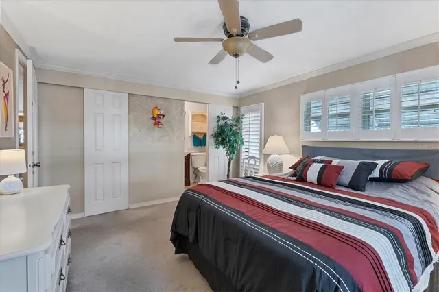 a bedroom with double bed and a chandelier
