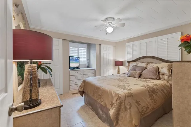 a bedroom with a bed and a flat tv screen on the dresser