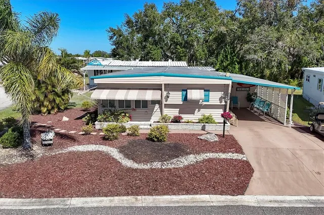 a view of a house with backyard porch and sitting area