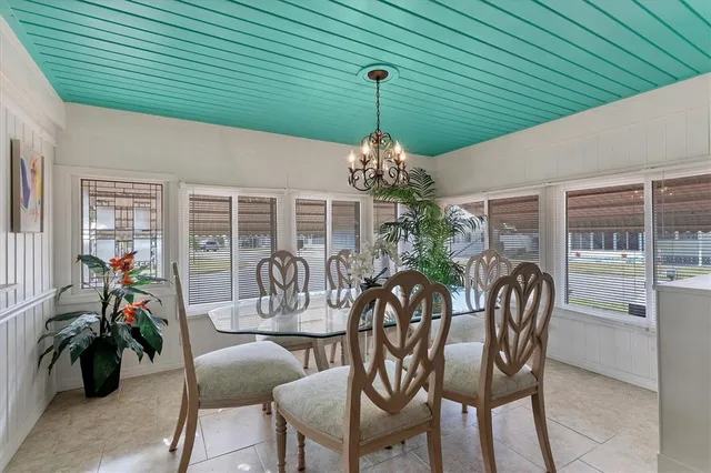 a view of a patio with table and chairs potted plants with wooden floor