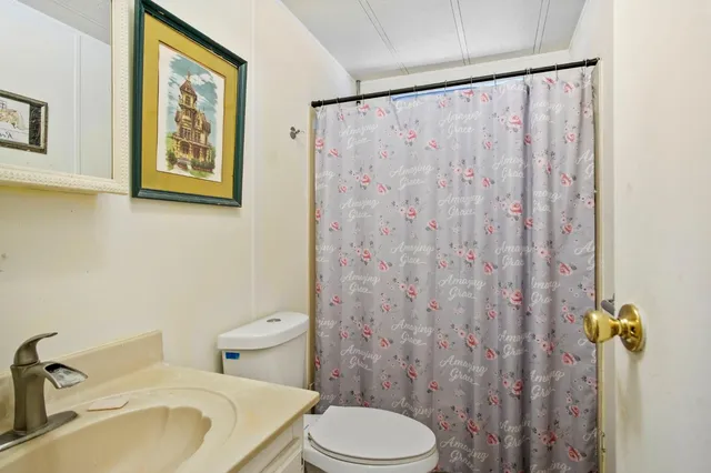 a bedroom with a bed and a computer on the desk