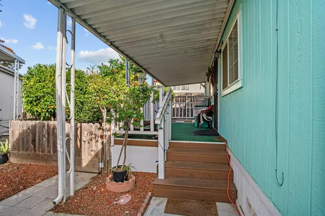 a view of a backyard with wooden fence