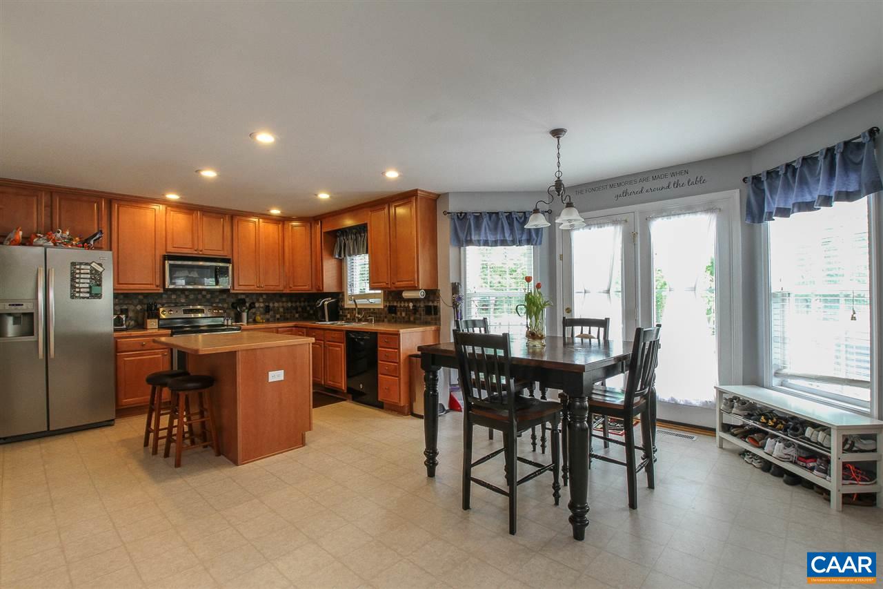 11 Ashton Road Palmyra, VA 22963 - Photo 5 of 30 a kitchen with stainless steel appliances granite countertop a table chairs and a refrigerator