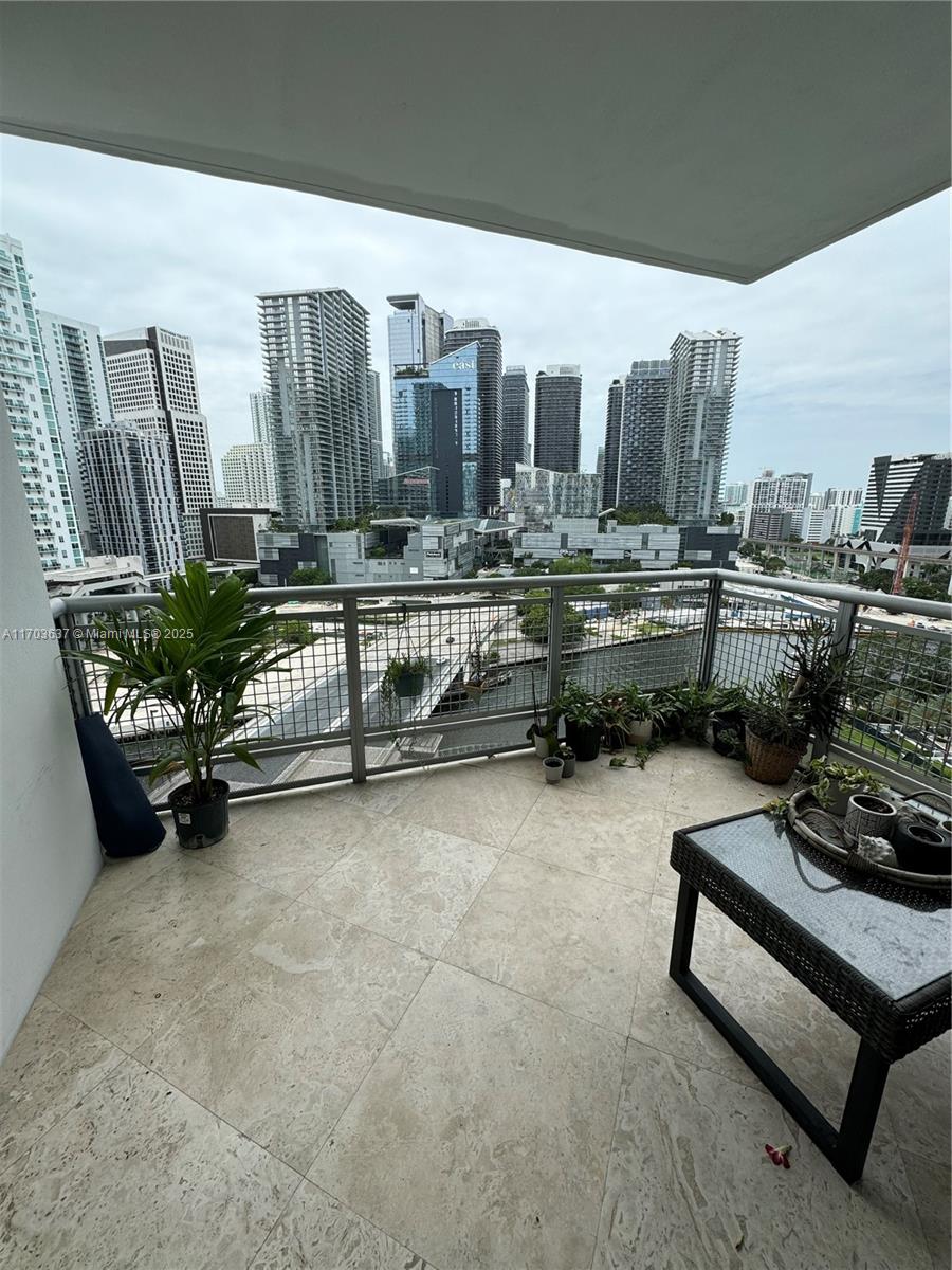 350 South Miami Avenue, Unit 1704 Miami, FL 33130 - Photo 4 of 13 a room with furniture and a chair