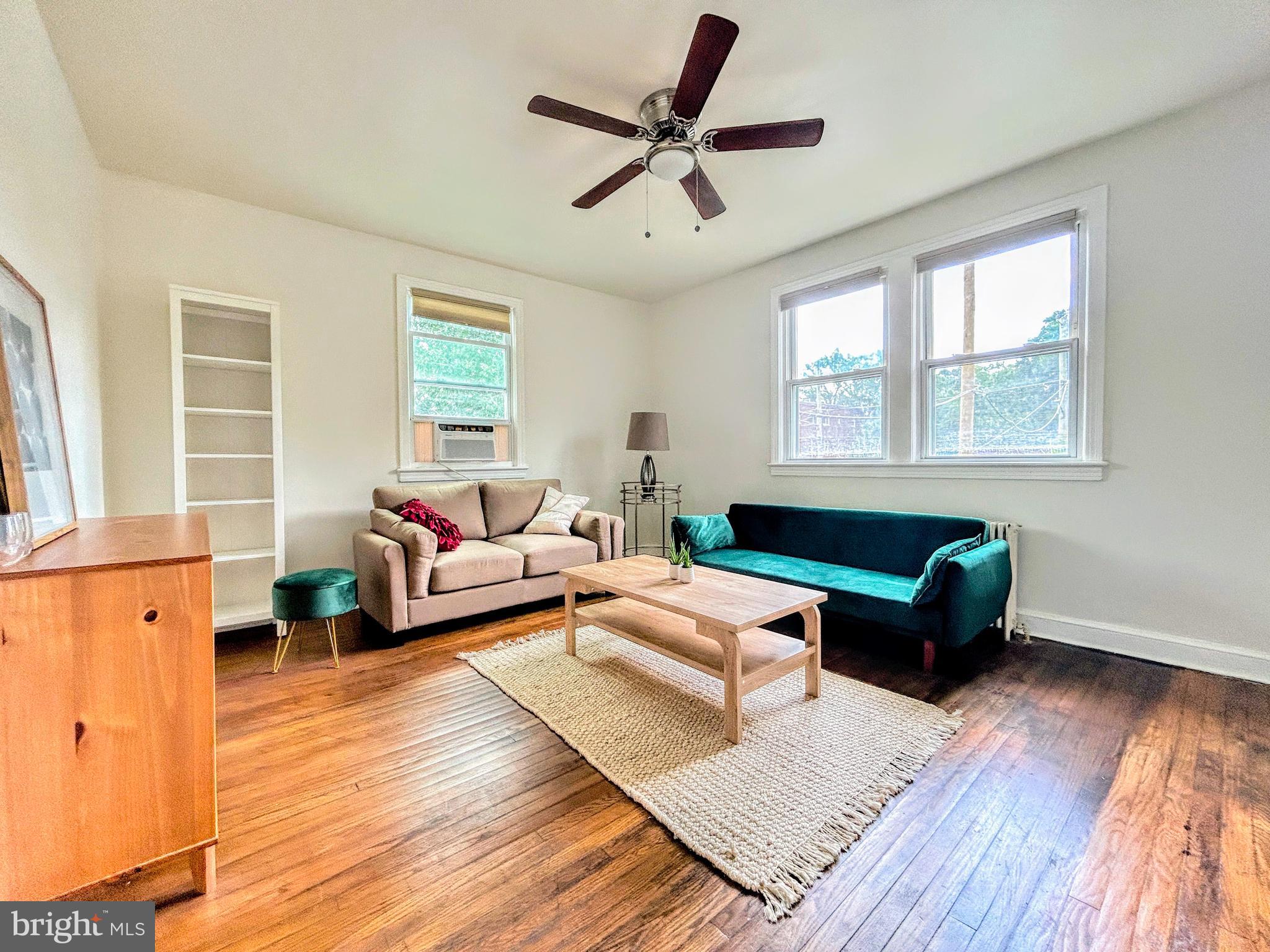 446 Mellon Street Southeast, Unit 4 Washington, DC 20032 - Photo 1 of 16 a living room with furniture and wooden floor