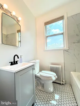 a bathroom with a sink toilet and mirror