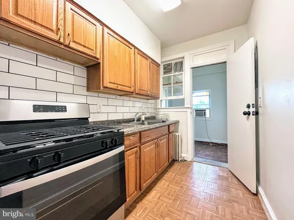 a kitchen with stainless steel appliances granite countertop a stove and a sink