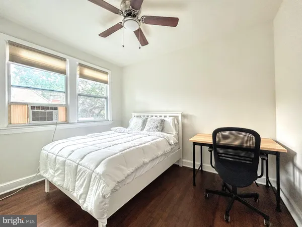 a bedroom with a bed and a desk