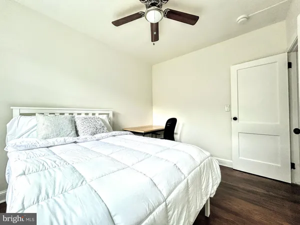 a bedroom with a bed and a ceiling fan