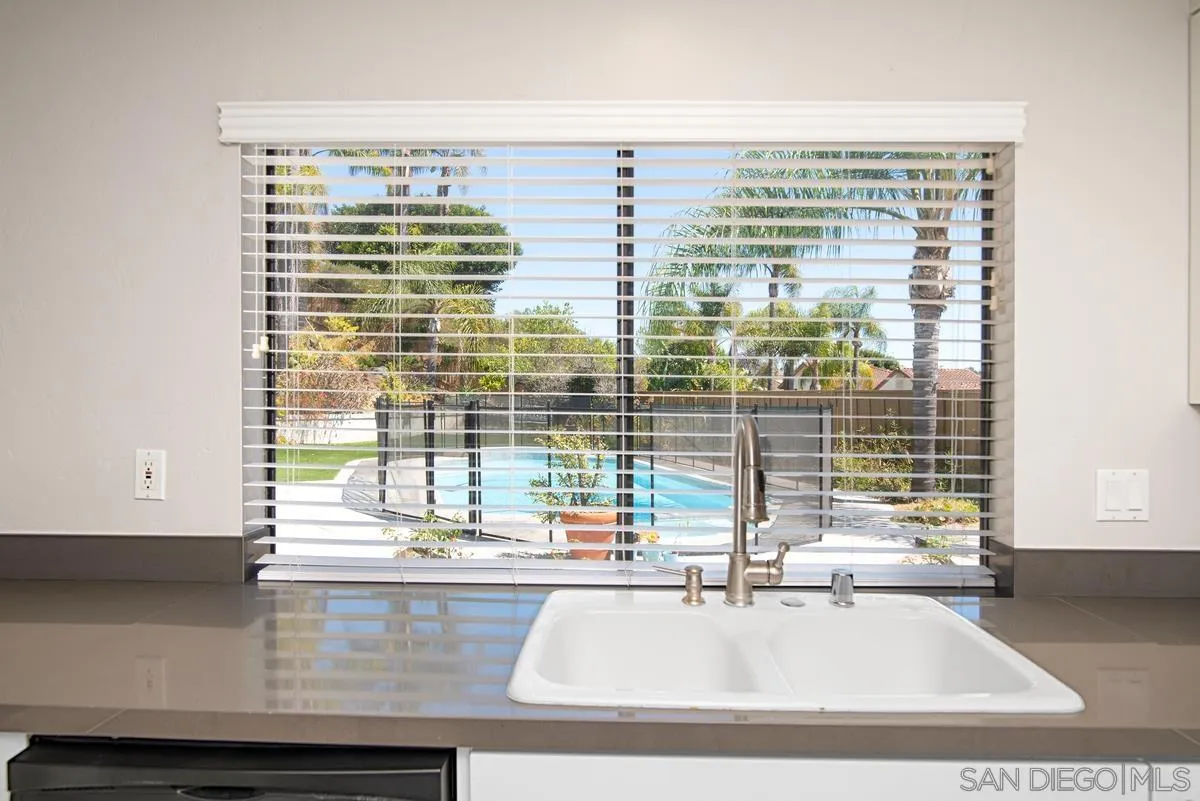 4031 Grayson Drive San Diego, CA 92130 - Photo 14 of 40 a bathroom with a granite countertop sink and a window