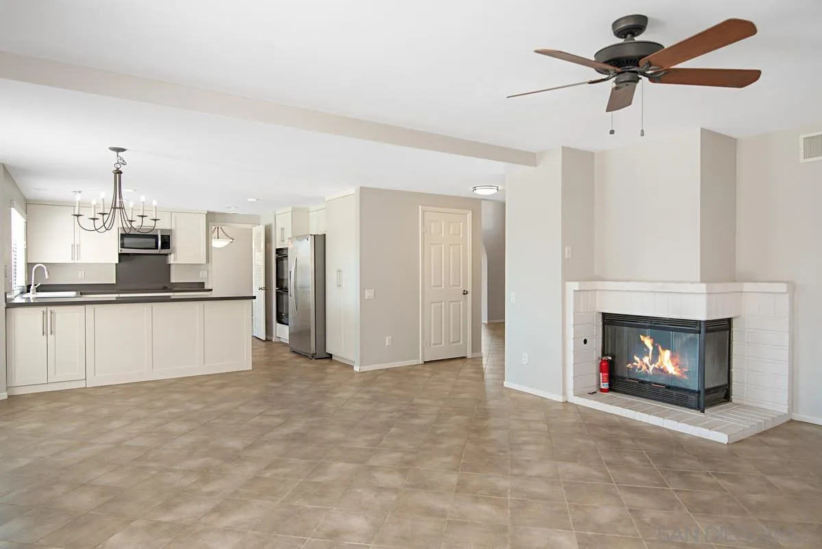 4031 Grayson Drive San Diego, CA 92130 - Photo 16 of 40 a view of a room with kitchen fireplace and a ceiling fan