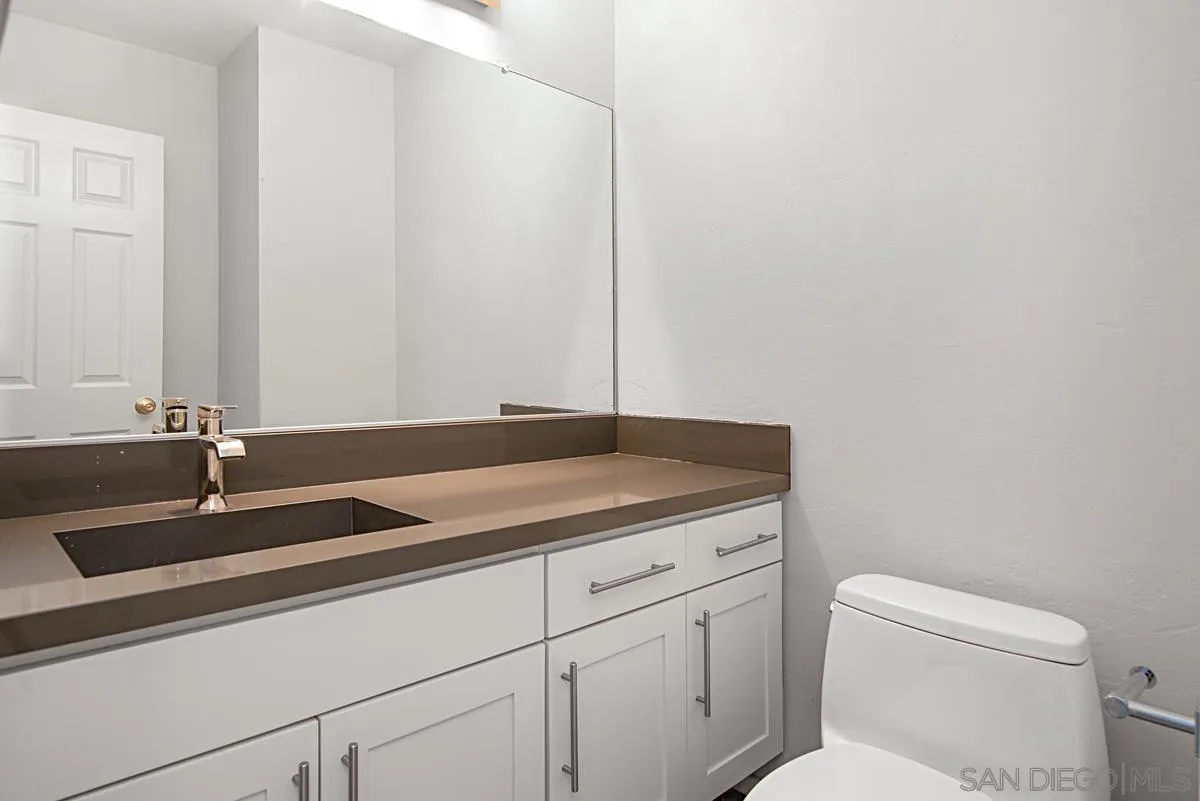 4031 Grayson Drive San Diego, CA 92130 - Photo 20 of 40 a bathroom with a toilet sink and mirror