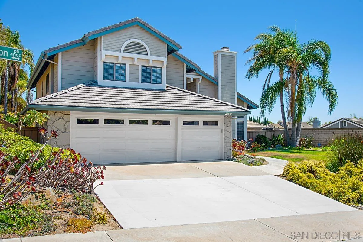 4031 Grayson Drive San Diego, CA 92130 - Photo 2 of 40 a front view of a house with a yard and garage