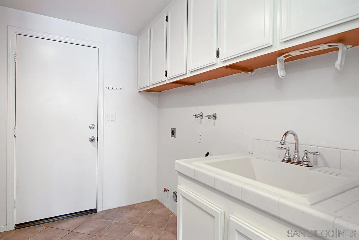 4031 Grayson Drive San Diego, CA 92130 - Photo 21 of 40 a bathroom with a sink and cabinets