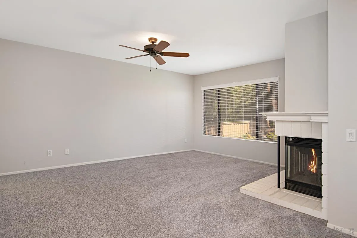 4031 Grayson Drive San Diego, CA 92130 - Photo 24 of 40 a view of a livingroom with a fireplace and window