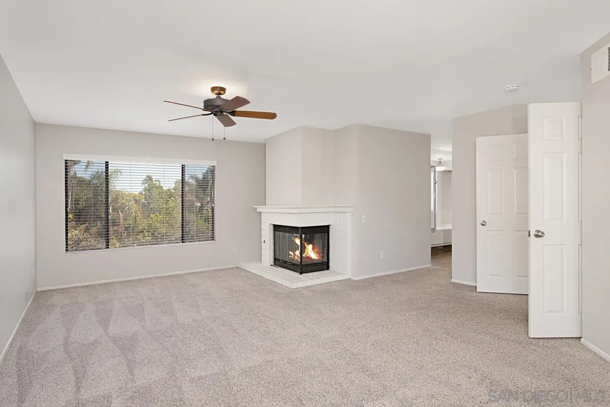 4031 Grayson Drive San Diego, CA 92130 - Photo 26 of 40 a view of an empty room with a fireplace and a window