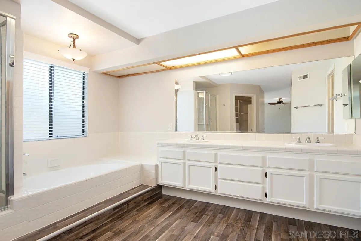 4031 Grayson Drive San Diego, CA 92130 - Photo 27 of 40 a spacious bathroom with a bathtub and a double vanity sink