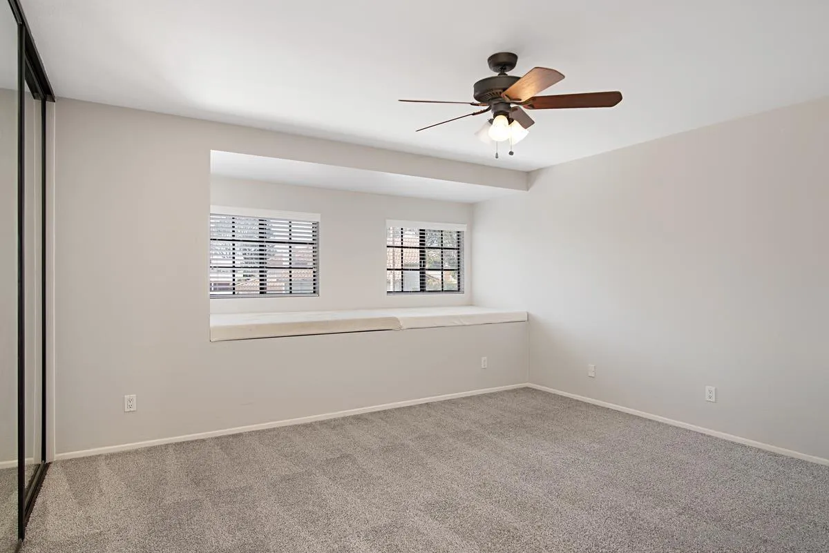 4031 Grayson Drive San Diego, CA 92130 - Photo 32 of 40 an empty room with ceiling fan and window