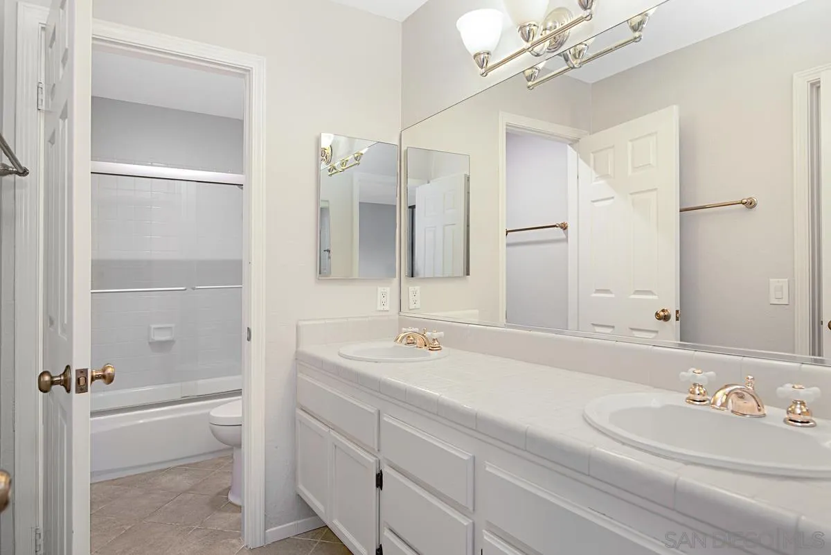 4031 Grayson Drive San Diego, CA 92130 - Photo 34 of 40 a bathroom with a sink double vanity and a mirror