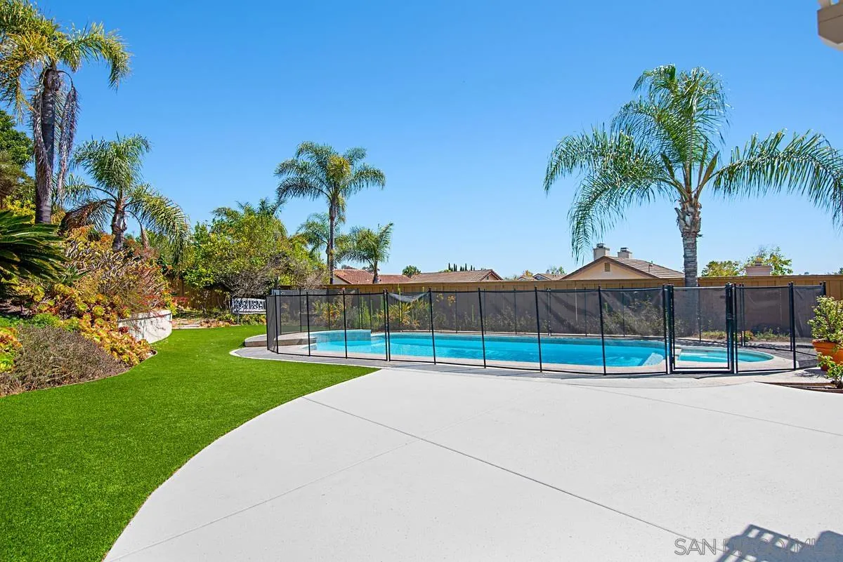 4031 Grayson Drive San Diego, CA 92130 - Photo 35 of 40 a view of swimming pool with a yard and palm trees