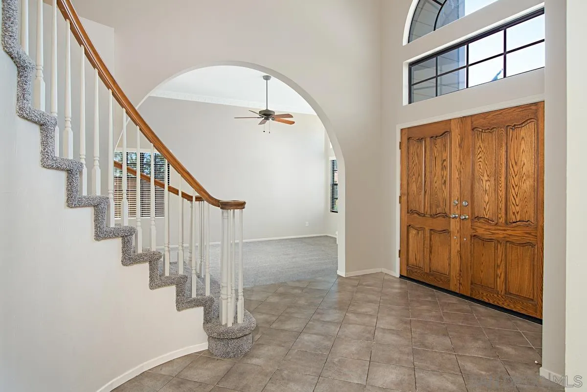 4031 Grayson Drive San Diego, CA 92130 - Photo 4 of 40 a view of entryway with wooden floor and stairs