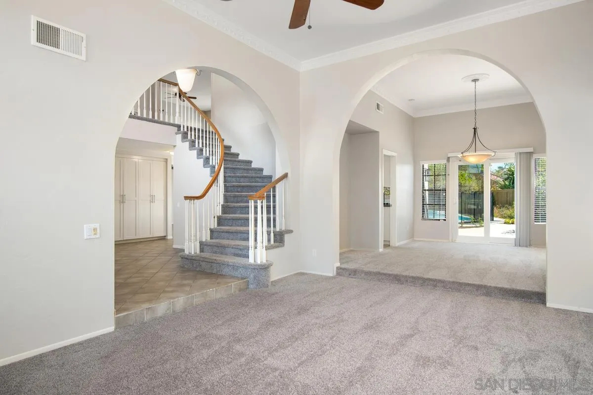 4031 Grayson Drive San Diego, CA 92130 - Photo 5 of 40 an empty room with stairs and wooden floor