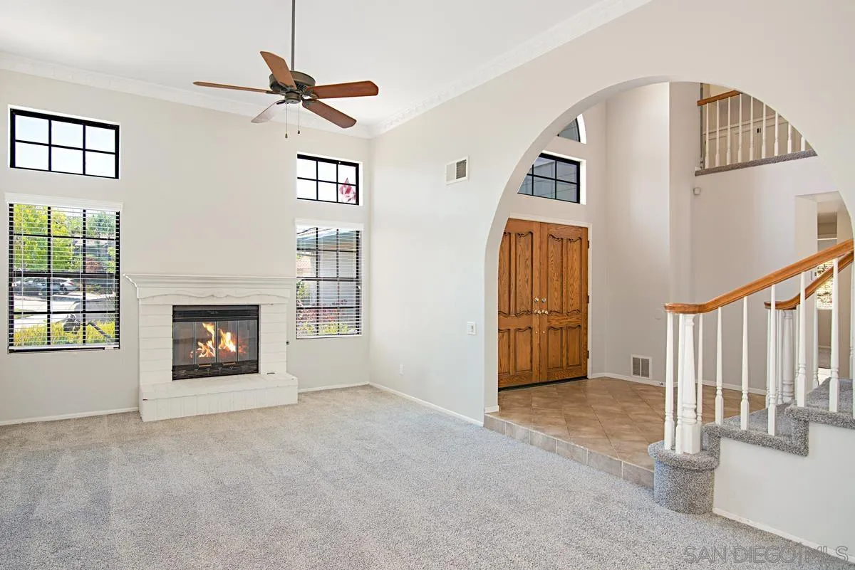 4031 Grayson Drive San Diego, CA 92130 - Photo 7 of 40 a view of a livingroom with a fireplace and stairs