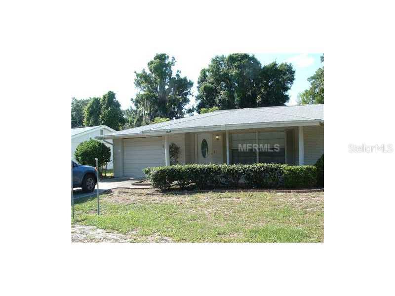 7624 Raintree Drive New Port Richey, FL 34653 - Photo 1 of 1 a view of house with a yard