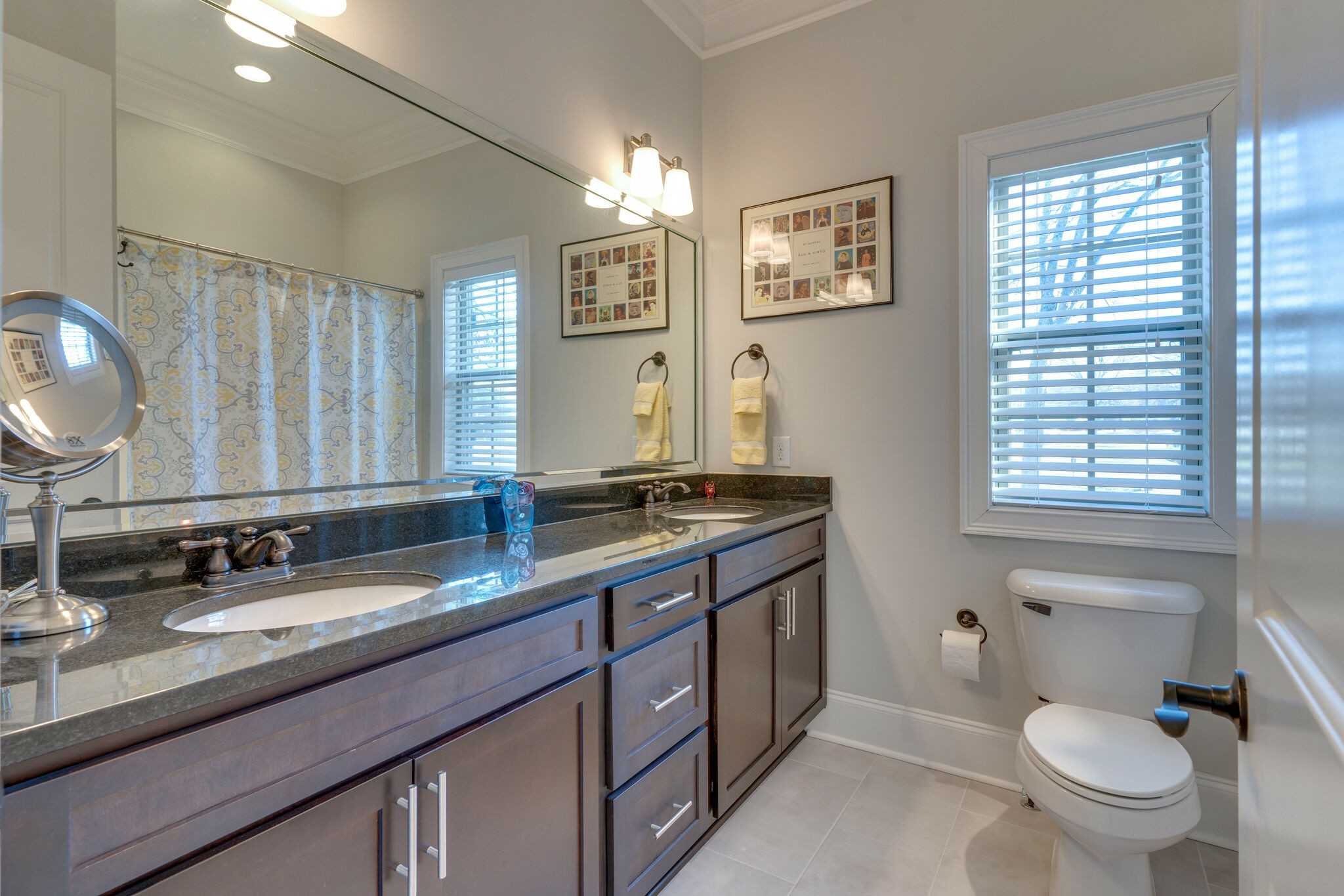 6400 Harding Pike Nashville, TN 37205 - Photo 29 of 38 a bathroom with double vanity sink a mirror a toilet and a window