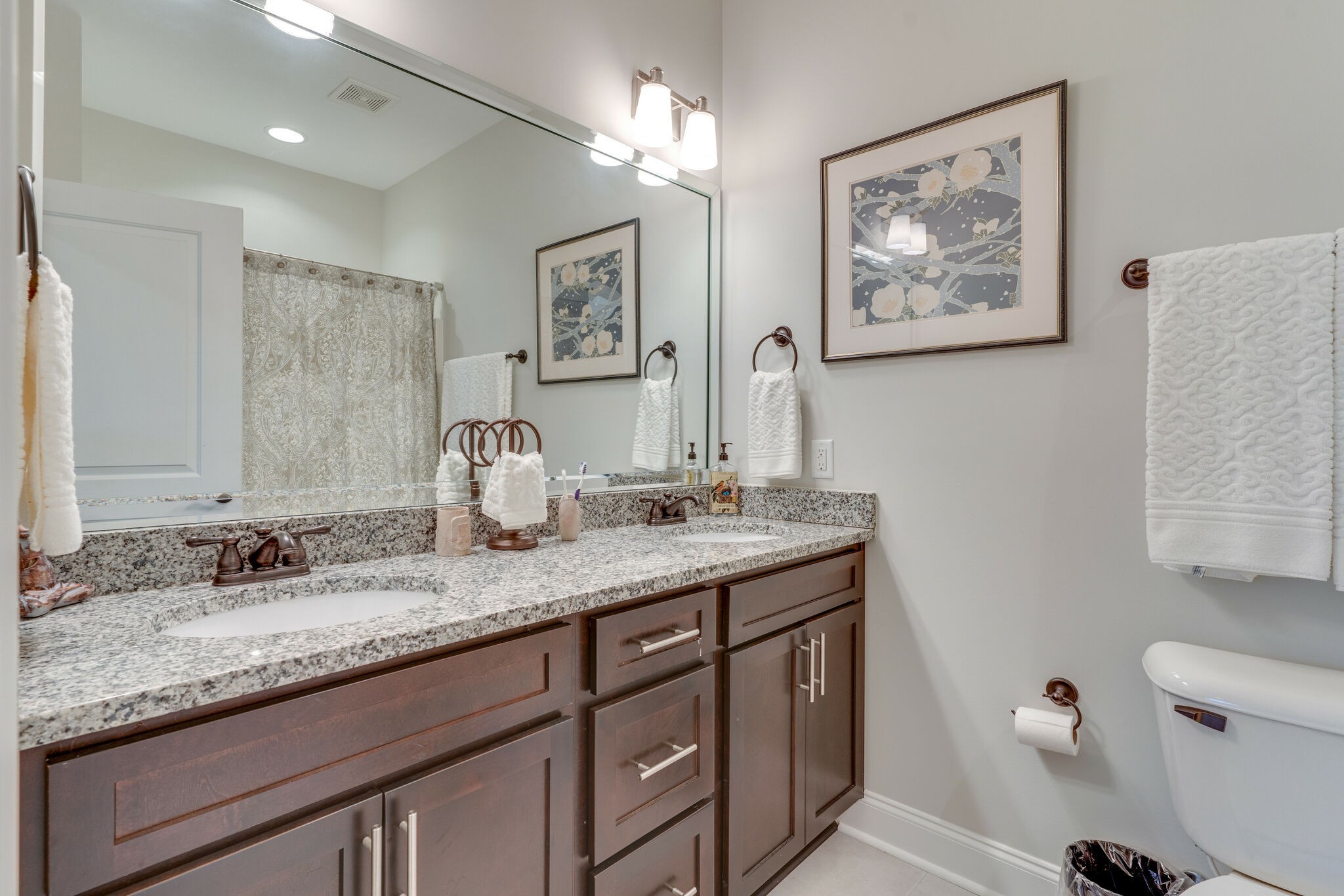 6400 Harding Pike Nashville, TN 37205 - Photo 32 of 38 a bathroom with a granite countertop sink a toilet and a mirror