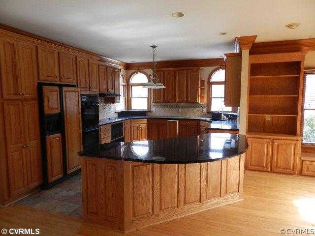 20800 River Road Chesterfield, VA 23838 - Photo 3 of 12 a kitchen with stainless steel appliances granite countertop a refrigerator a stove and a sink with wooden cabinets
