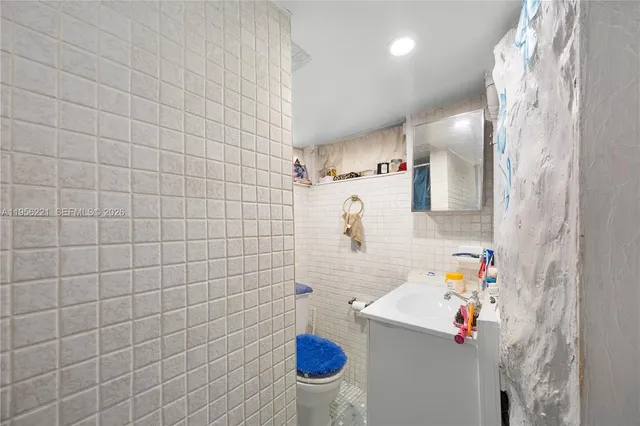 a bathroom with a sink a tub and a shower curtain