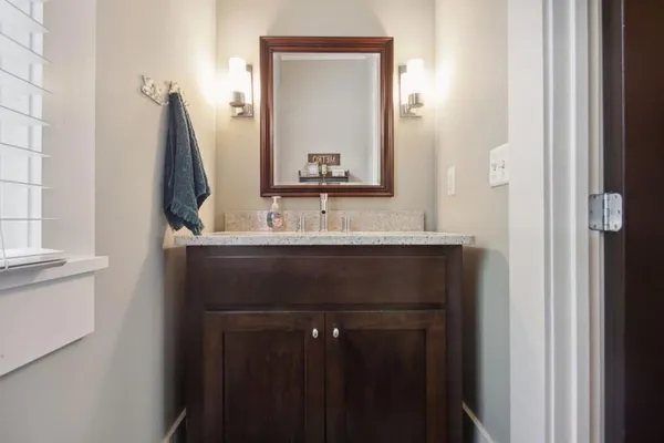 a bathroom with a sink vanity and a mirror