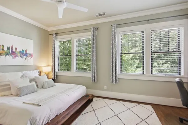 a spacious bedroom with a bed and a large window