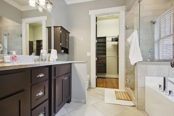 a bathroom with a tub sink and mirror