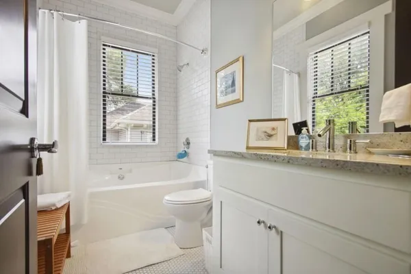 a bathroom with a sink a toilet and bathtub