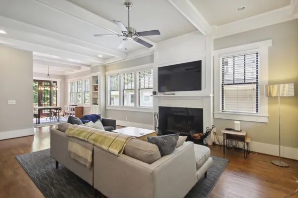 a living room with furniture a fireplace and a flat screen tv