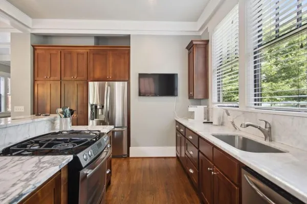 a kitchen with a sink stove top oven and cabinets