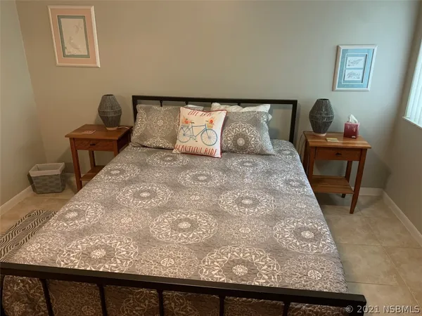 a view of a bedroom with wooden floor and chair