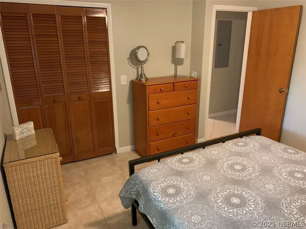 a bedroom with a bed and cabinets