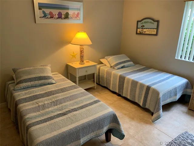 a bedroom with bed and a lamp on table