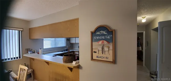 a kitchen with a refrigerator and a stove top oven