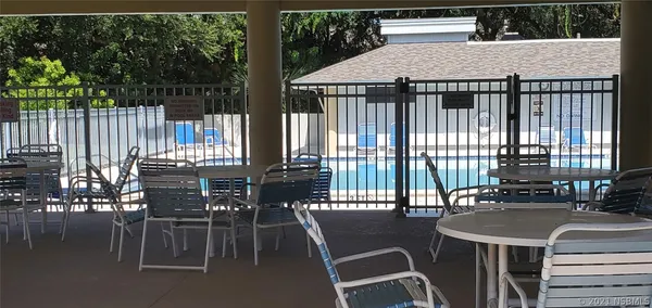 a roof deck with a table and chairs