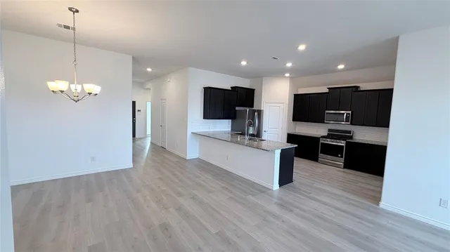 a view of kitchen with sink microwave and stove