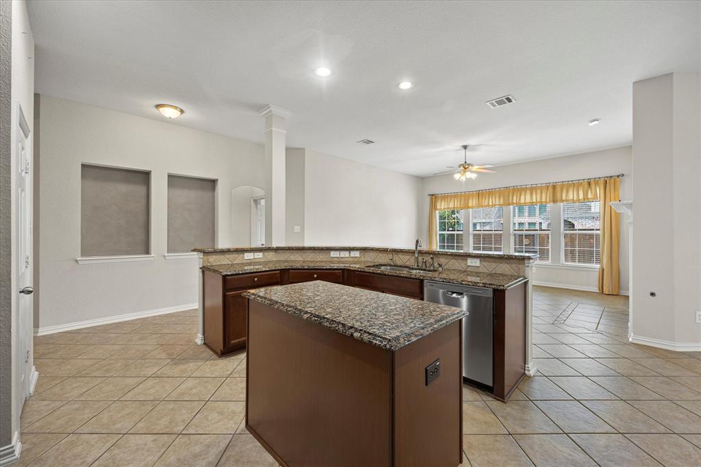 207 Leonard Way Fate, TX 75087 - Photo 14 of 31 a kitchen with granite countertop a sink and a stove