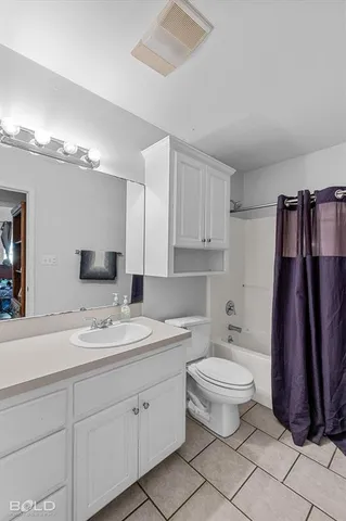 a bathroom with a double vanity sink toilet and a mirror