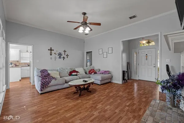 a living room with furniture and wooden floor
