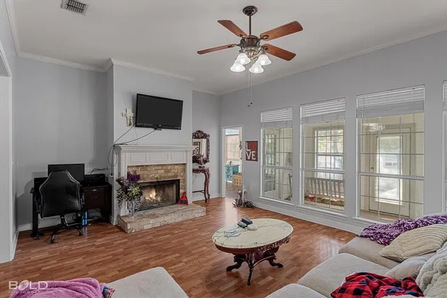 a living room with furniture a fireplace and a flat screen tv